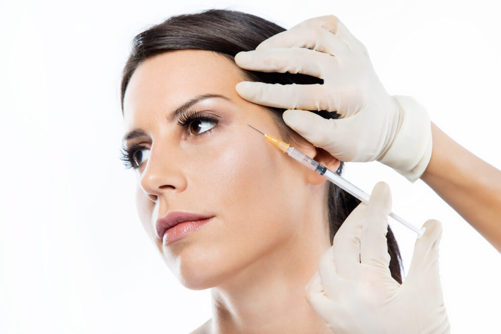 Female model and medical provider demonstrating a cosmetic neurotoxin injection procedure.