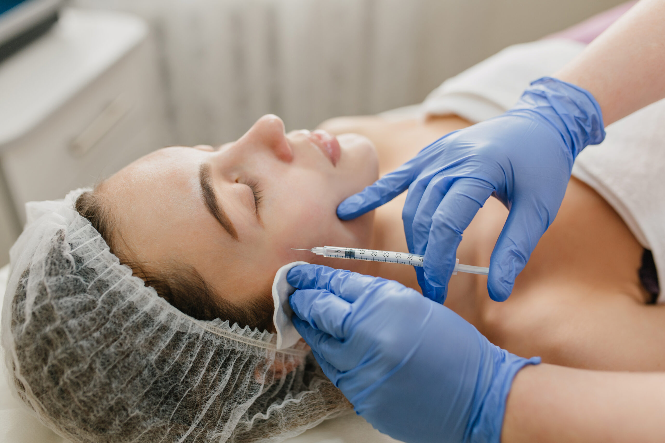 Woman receiving a cosmetic neurotoxin injection treatment.